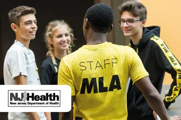 Students chatting with an MLA staff member, with the NJ Health department logo