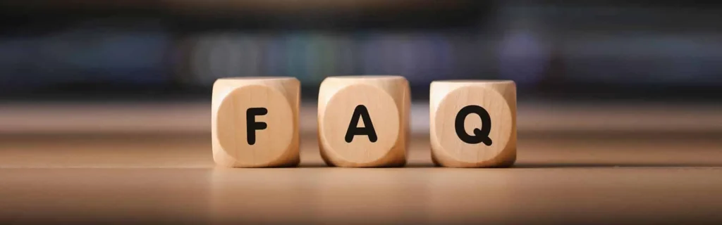 Wooden cubes spelling FAQ on a desk with a blurred background