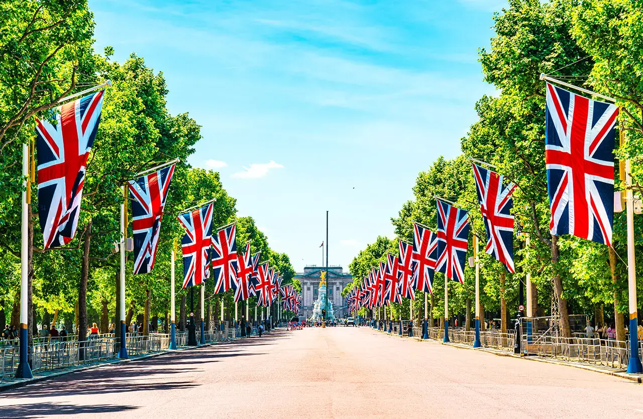 Union Jack flags lining The Mall towards Buckingham Palace and the Victoria Memorial in London